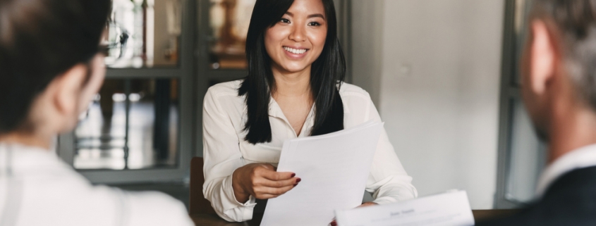 Young Asian women being interviewed by a man and a woman